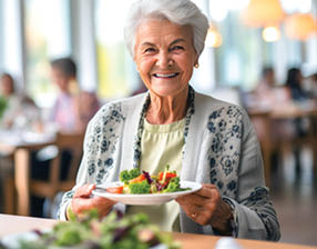 Portrait of a senior woman in a retirement home happily enjoying a healthy lunch. Presentation of a healthy lifestyle of well-being and contentment even at an age